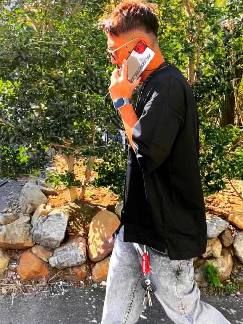 ブラック系のTシャツ/カットソー、グレー系のデニムパンツ、グレー系のスニーカーを着用したメンズの秋コーディネートの5枚目の写真