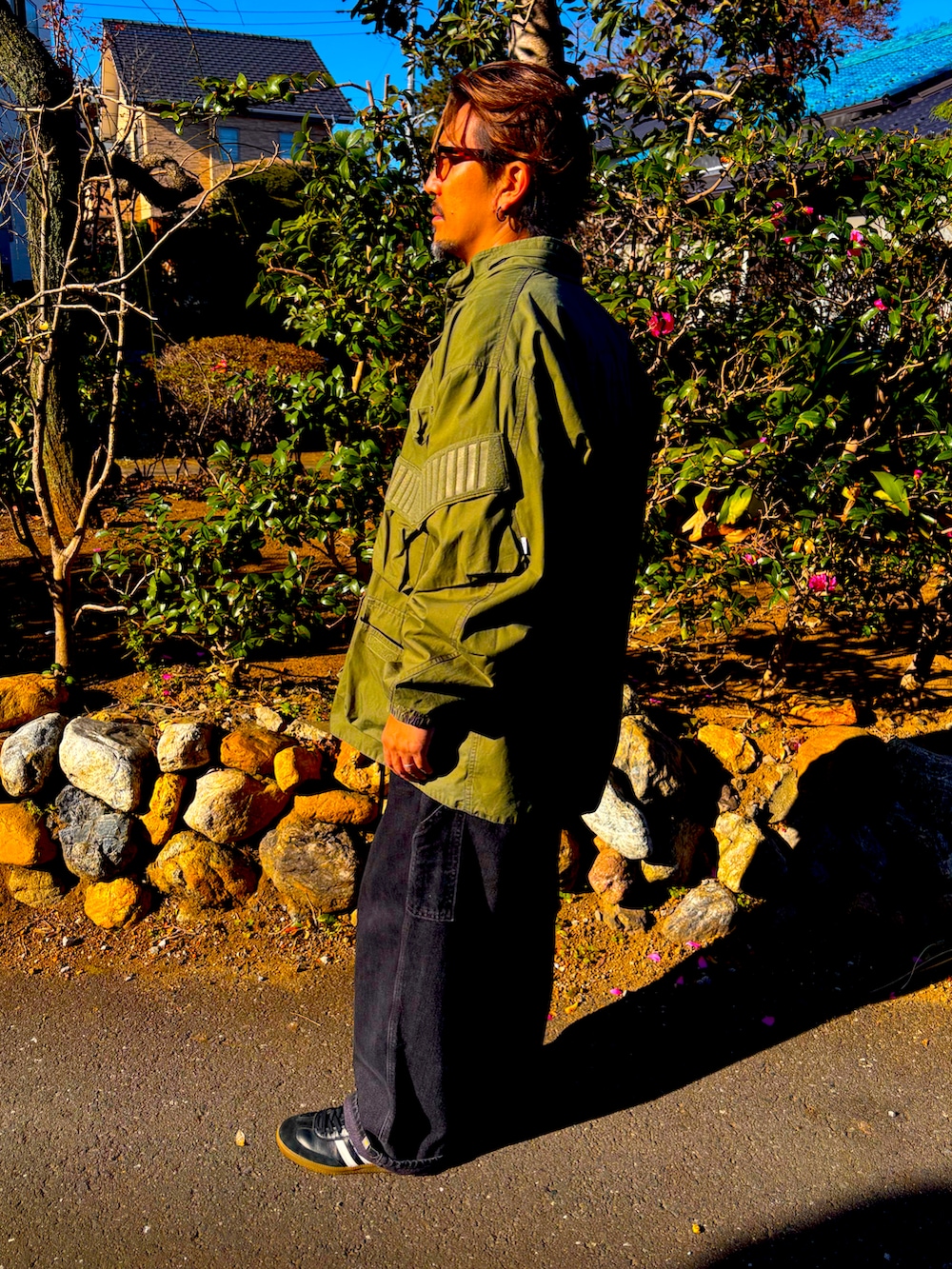 ブラック系のスニーカー、グレー系のスウェット、ブラック系のデニムパンツを着用したメンズの冬コーディネートの4枚目の写真