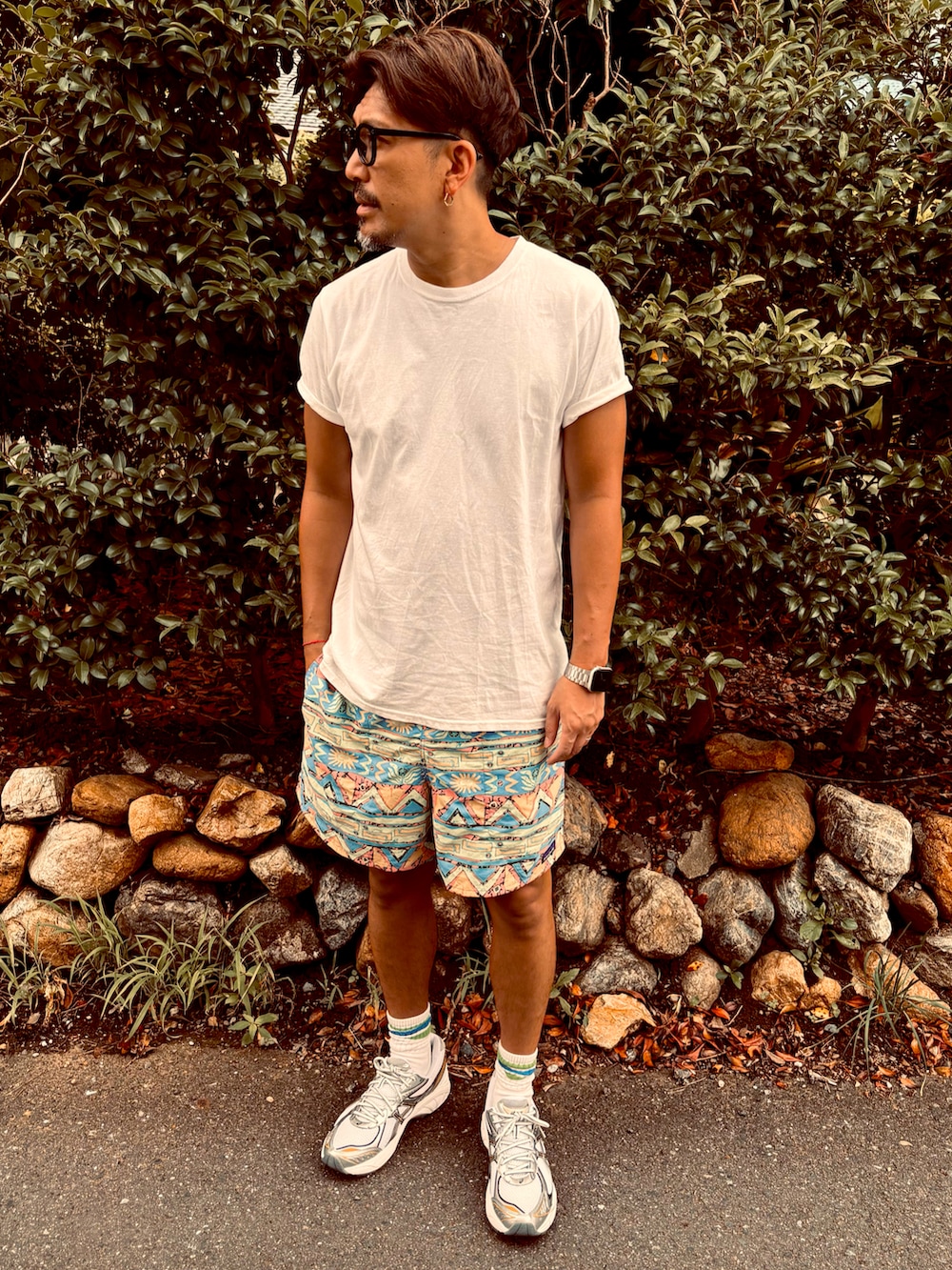 ベージュ系のTシャツ/カットソー、グリーン系のその他パンツ、シルバー系のスニーカーを着用したメンズの夏コーディネートの2枚目の写真