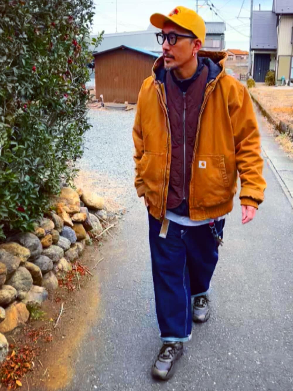 ブラウン系のベスト、ブラック系のナイロンジャケット、ブラウン系のブルゾンを着用したメンズの冬コーディネートの2枚目の写真