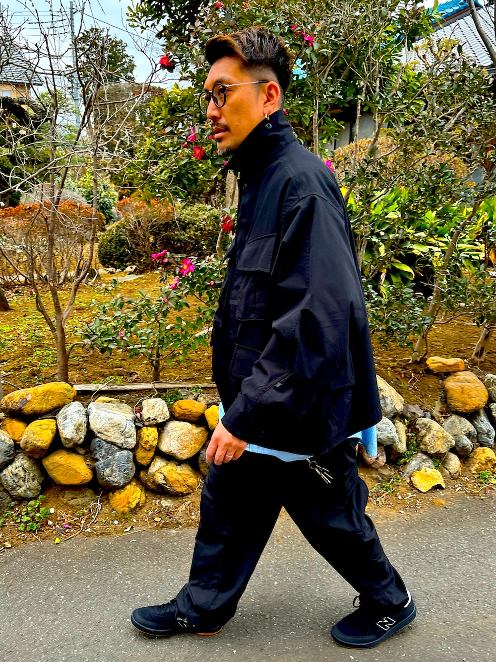 ブラック系のミリタリージャケット、ブルー系のシャツ/ブラウス、ブラック系のカーゴパンツを着用したメンズの冬コーディネートの4枚目の写真