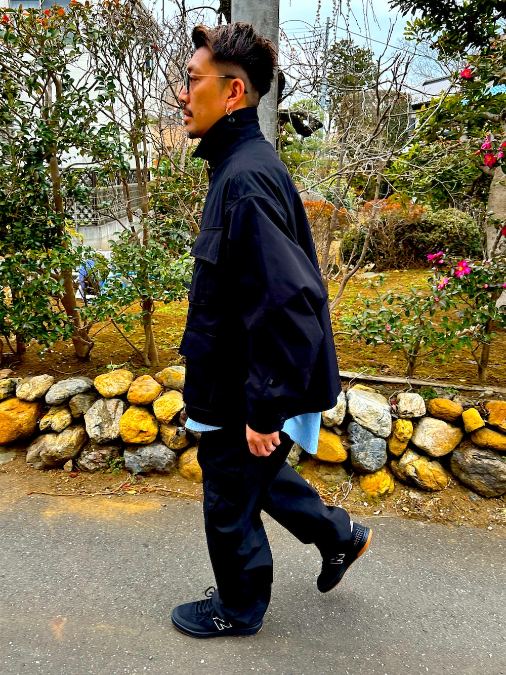 ブラック系のミリタリージャケット、ブルー系のシャツ/ブラウス、ブラック系のカーゴパンツを着用したメンズの冬コーディネートの5枚目の写真