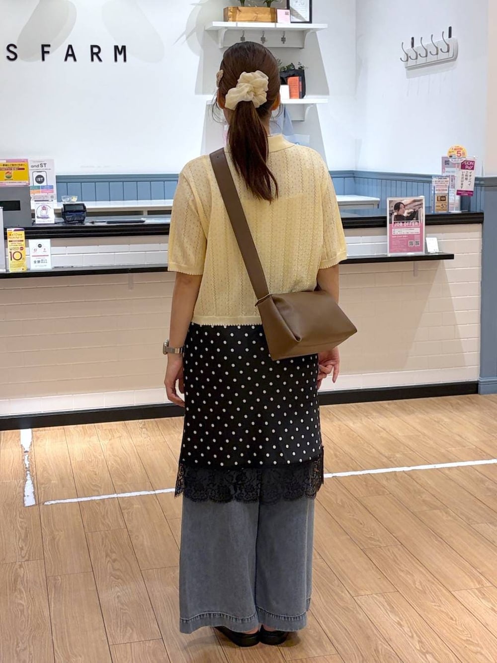 イエロー系のカーディガン/ボレロ、ブラウン系のサンダル、ブラウン系のショルダーバッグを着用したレディースの夏コーディネートの3枚目の写真