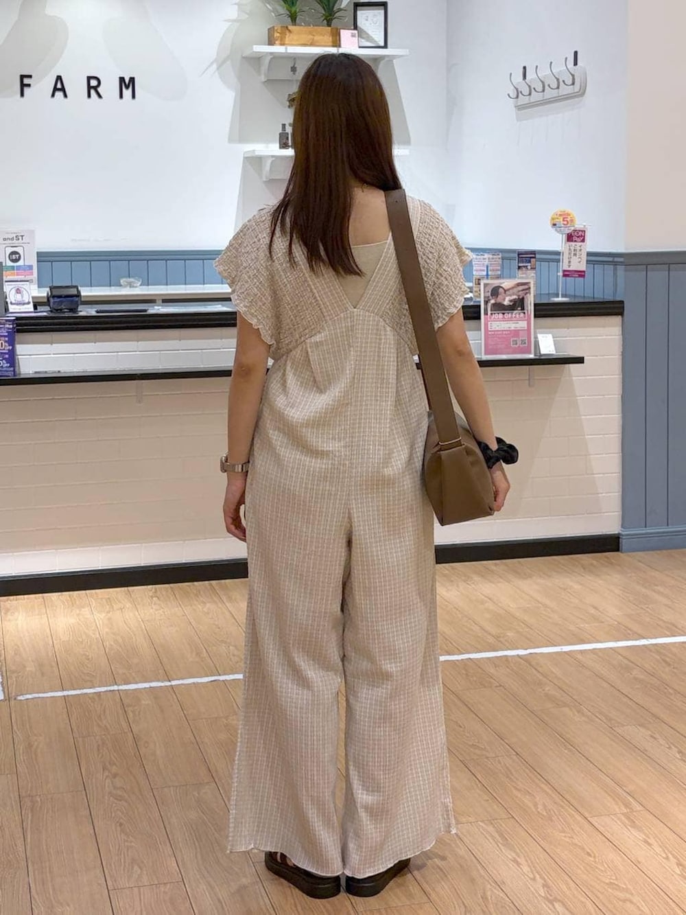 ベージュ系のサロペット/オーバーオール、ブラウン系のサンダル、ブラウン系のショルダーバッグを着用したレディースの夏コーディネートの4枚目の写真