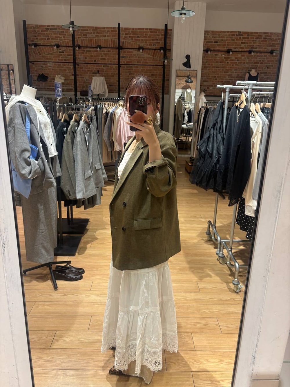 ブラウン系のパンプス、ブラウン系のその他アウター、オレンジ系のデニムパンツを着用したレディースの春コーディネートの3枚目の写真