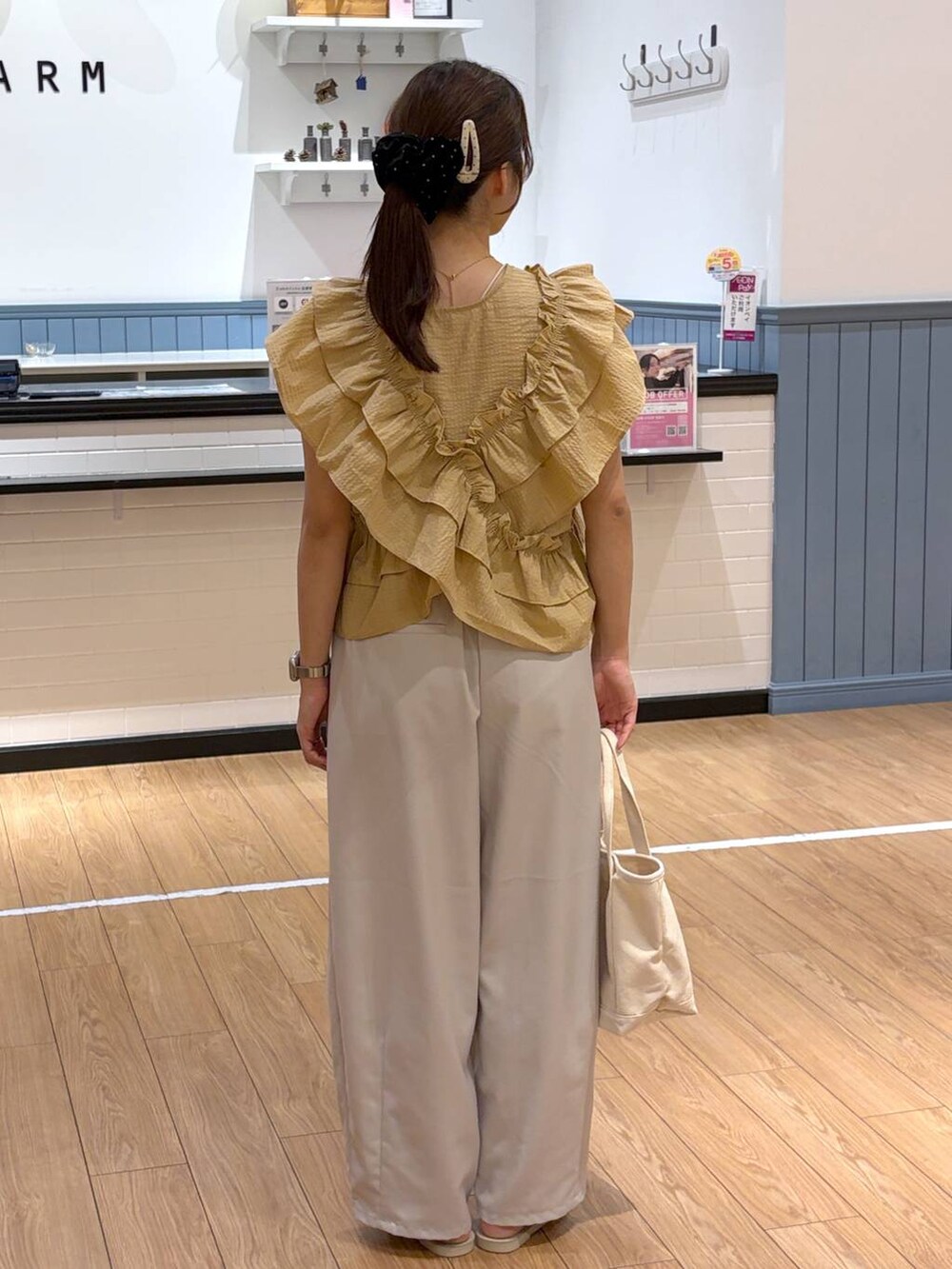 ホワイト系のショルダーバッグ、ブラウン系のその他パンツ、ホワイト系のサンダルを着用したレディースの夏コーディネートの3枚目の写真