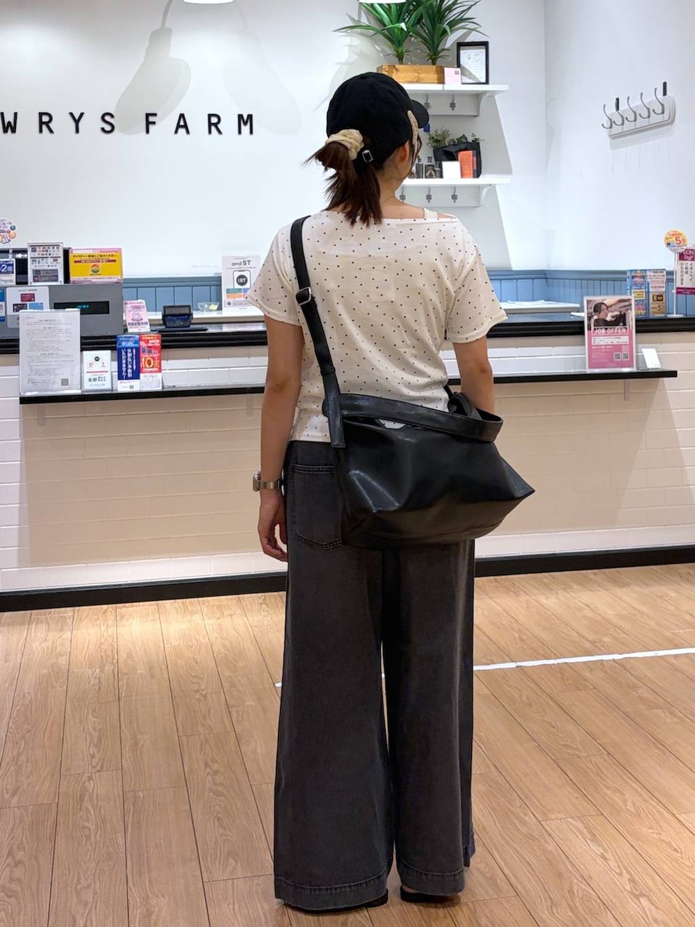 ベージュ系のTシャツ/カットソー、ブラック系のサンダル、ブラック系のショルダーバッグを着用したレディースの夏コーディネートの3枚目の写真