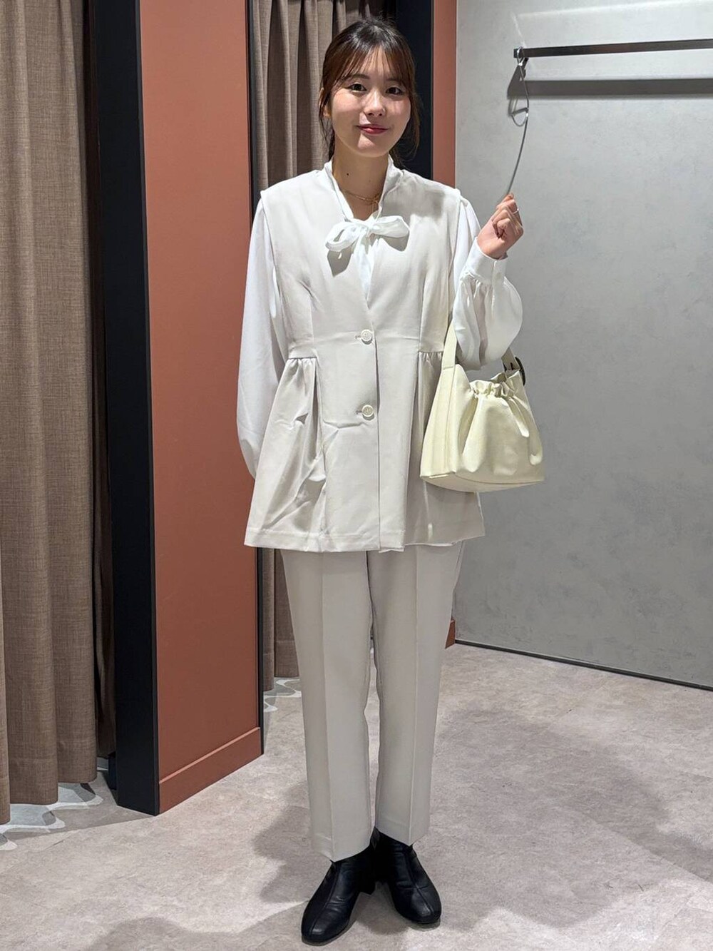 ブラック系のブーツ、ホワイト系のショルダーバッグ、ホワイト系のその他パンツを着用したレディースの冬コーディネートの4枚目の写真