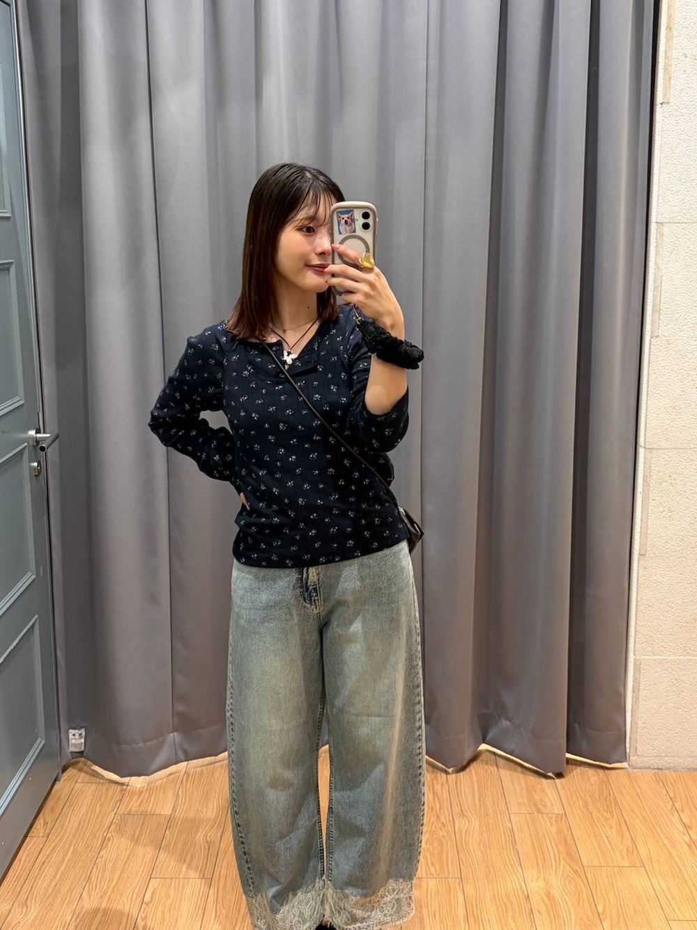 ブラウン系のボディバッグ/ウエストポーチ、ブルー系のデニムパンツ、ブラック系のローファーを着用したレディースの秋コーディネートの2枚目の写真