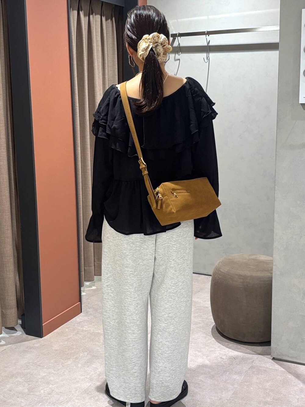 ブラック系のサンダル、グレー系のスウェットパンツ、ブラウン系のショルダーバッグを着用したレディースの夏コーディネートの3枚目の写真