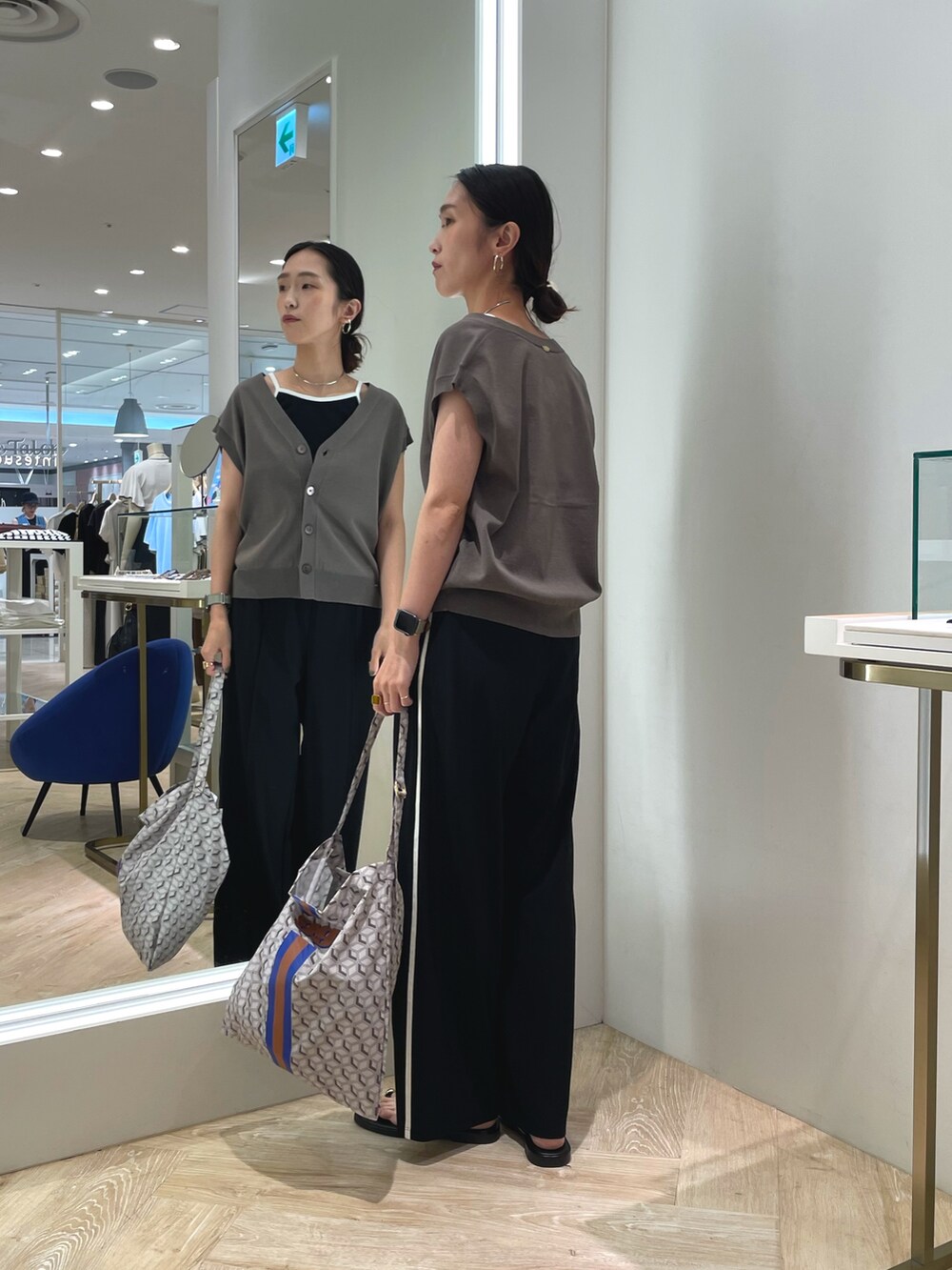ブラック系のその他パンツ、グリーン系のベスト、ブラック系のキャミソールを着用したレディースの夏コーディネートの3枚目の写真