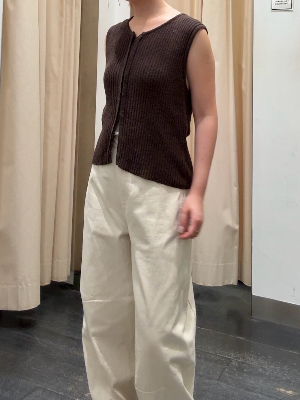 ブラウン系のベスト、ホワイト系のその他パンツ、イエロー系のサンダルを着用したレディースの夏コーディネートの4枚目の写真