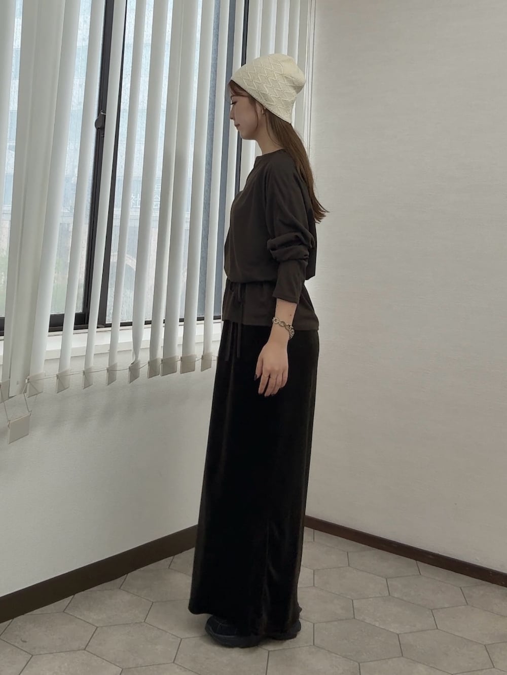 ブラウン系のTシャツ/カットソー、グリーン系のセットアップ、ブラック系のスニーカーを着用したレディースの秋コーディネートの2枚目の写真