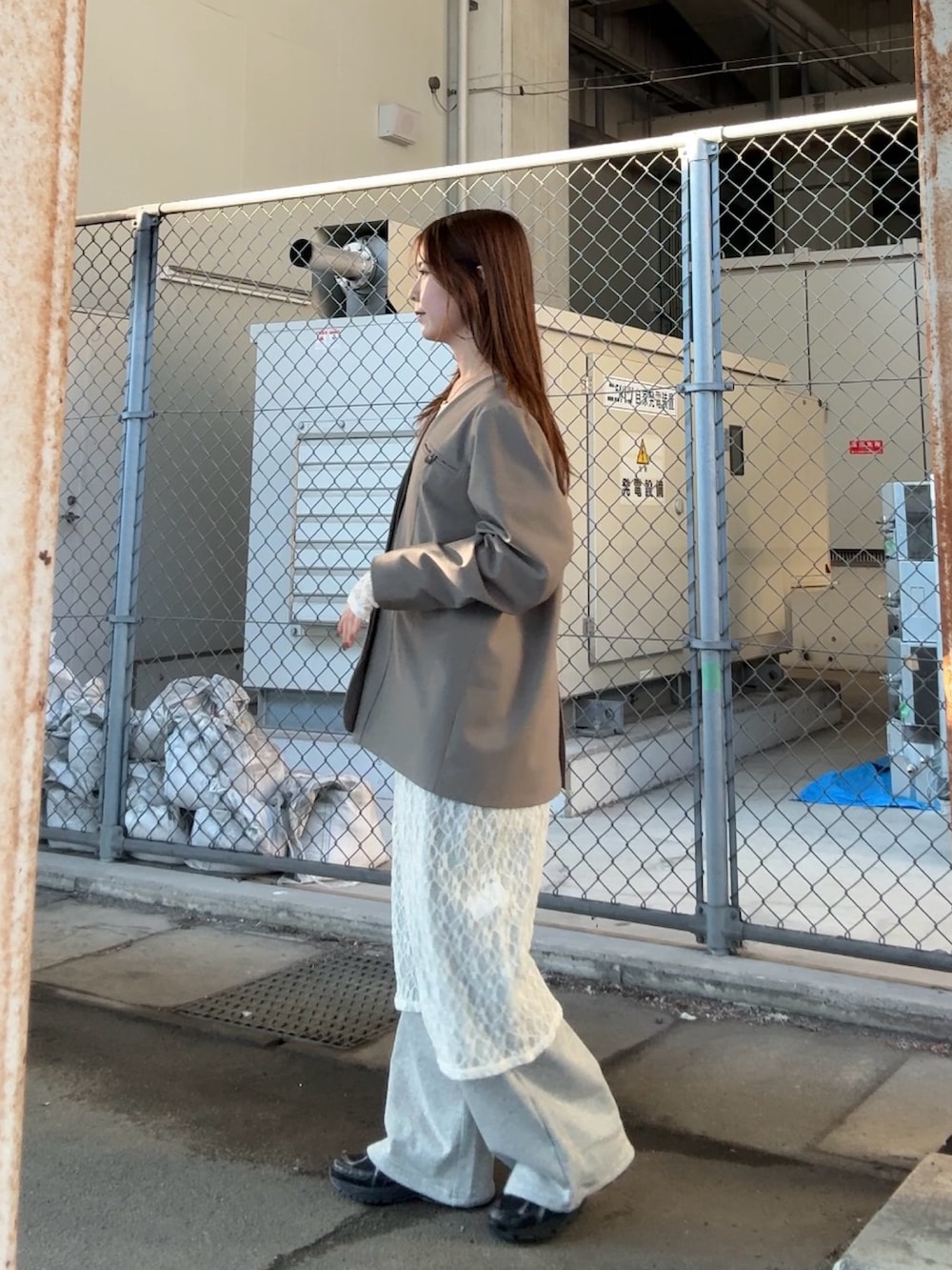 グレー系のノーカラージャケット、ホワイト系のワンピース、グレー系のその他パンツを着用したレディースの春コーディネートの2枚目の写真