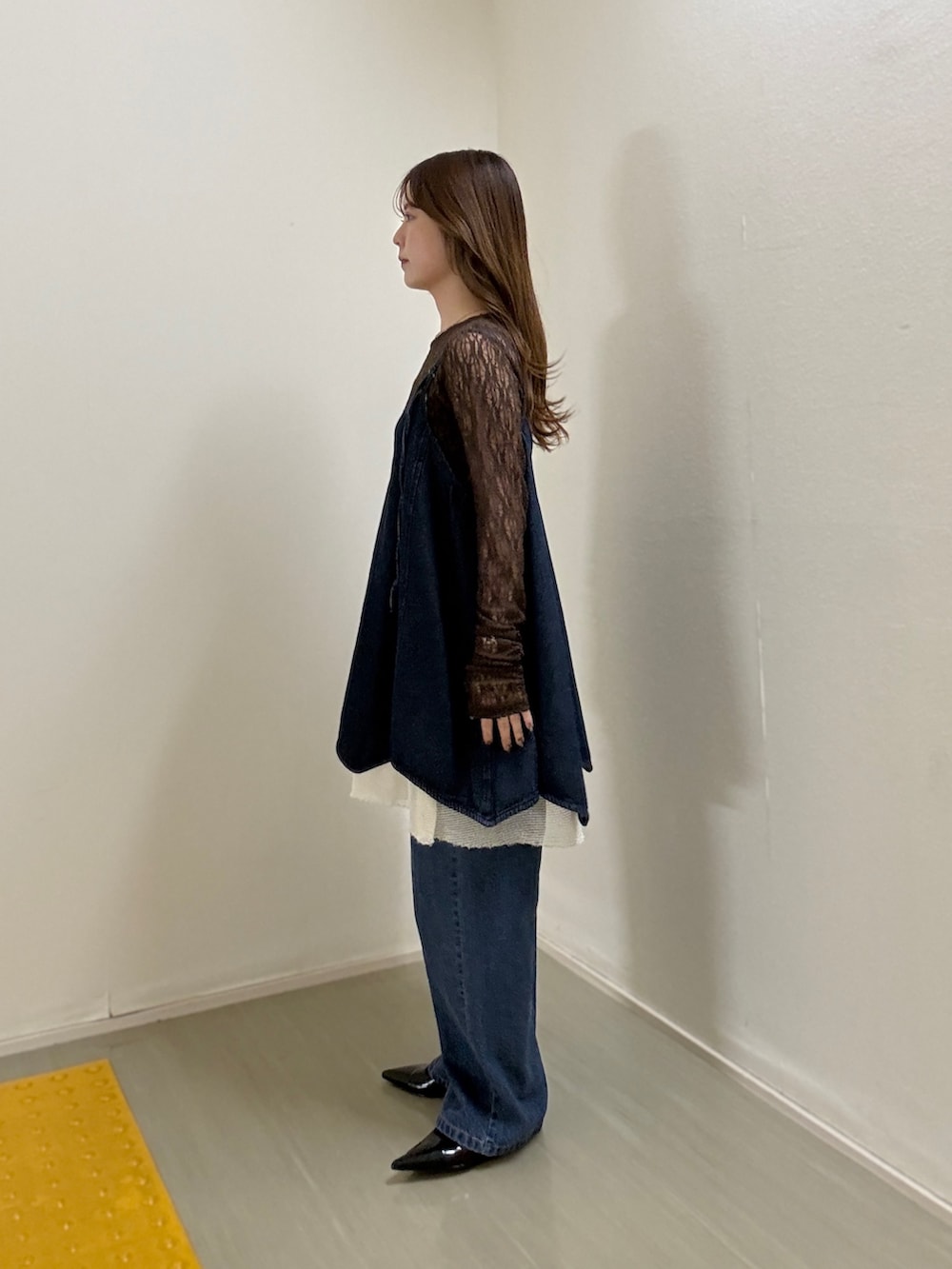 ブラウン系のTシャツ/カットソー、ブルー系のワンピース、ブルー系のデニムパンツを着用したレディースの春コーディネートの2枚目の写真