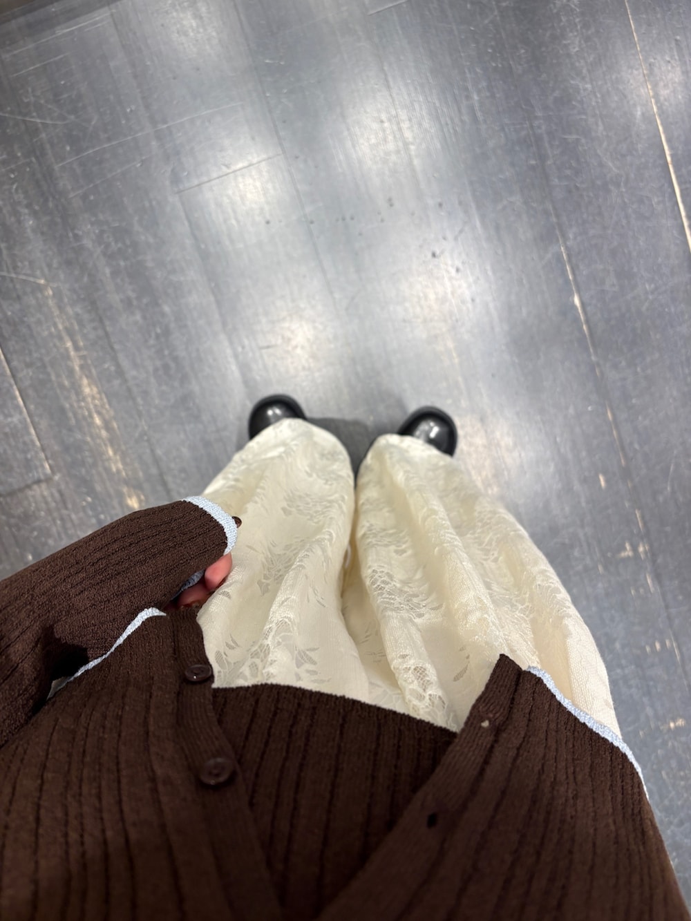 ブラウン系のニット/セーター、ホワイト系のその他パンツ、ブラック系のサンダルを着用したレディースの冬コーディネートの4枚目の写真