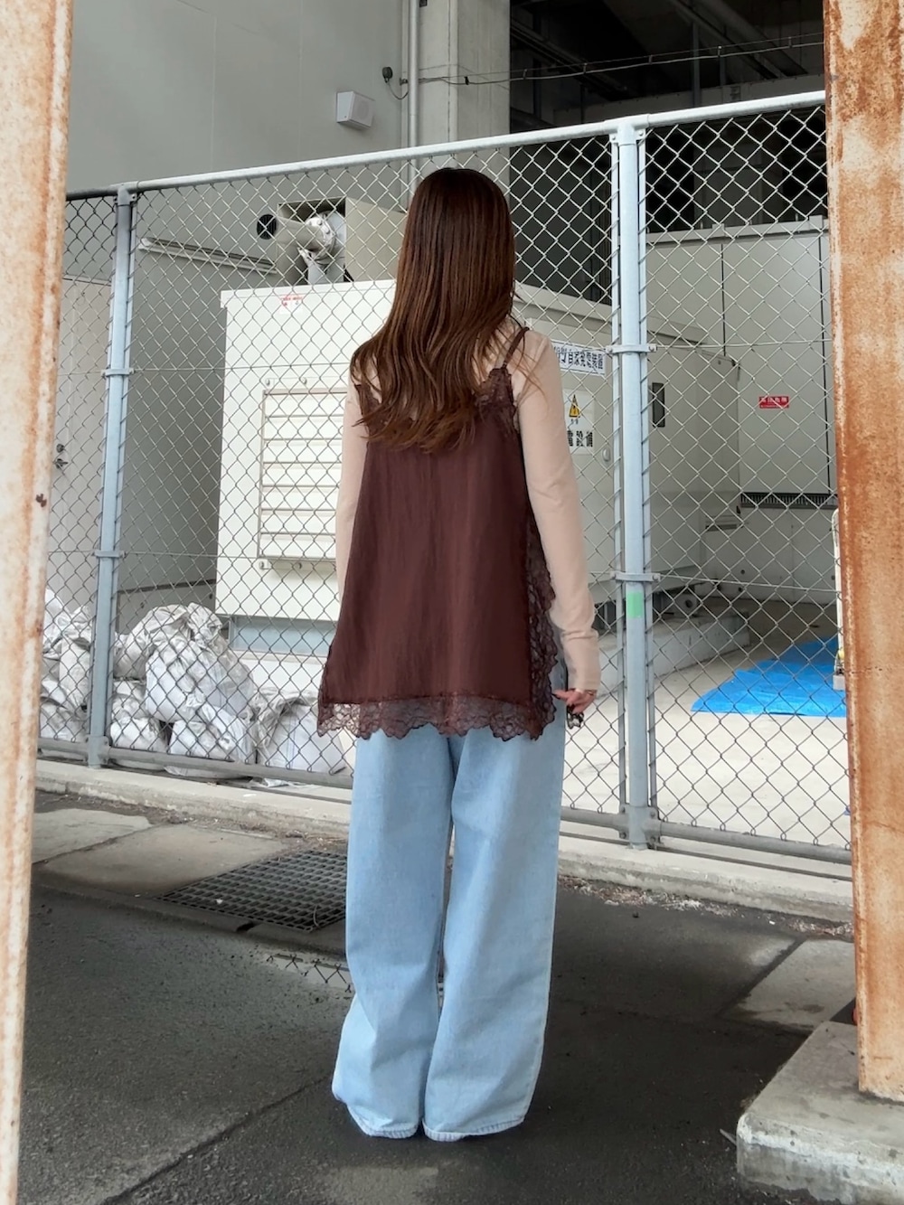 ブラウン系のキャミソール、ベージュ系のTシャツ/カットソー、ブルー系のデニムパンツを着用したレディースの春コーディネートの3枚目の写真