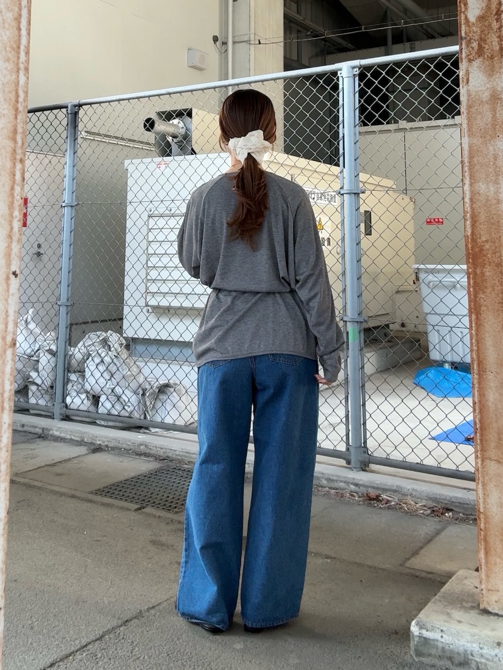 グレー系のTシャツ/カットソー、ブルー系のデニムパンツ、ホワイト系のヘアゴムを着用したレディースの春コーディネートの3枚目の写真