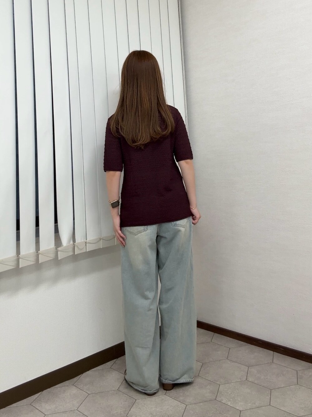 レッド系のニット/セーター、ブルー系のデニムパンツ、ブラウン系のサンダルを着用したレディースの夏コーディネートの3枚目の写真