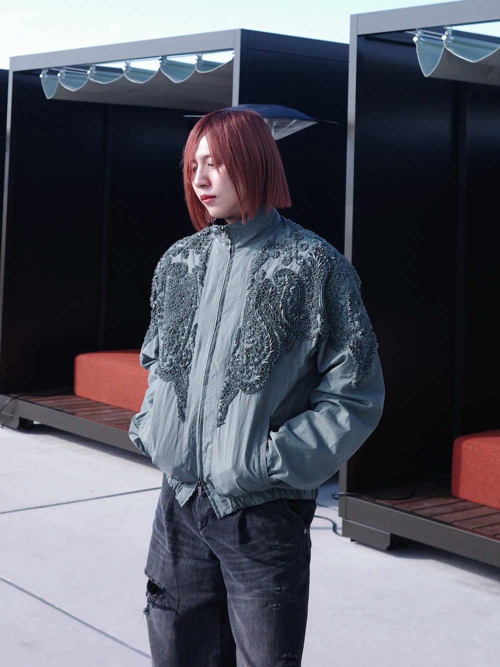 グレー系のブルゾン、ブラック系のデニムパンツを着用したメンズの冬コーディネートの2枚目の写真