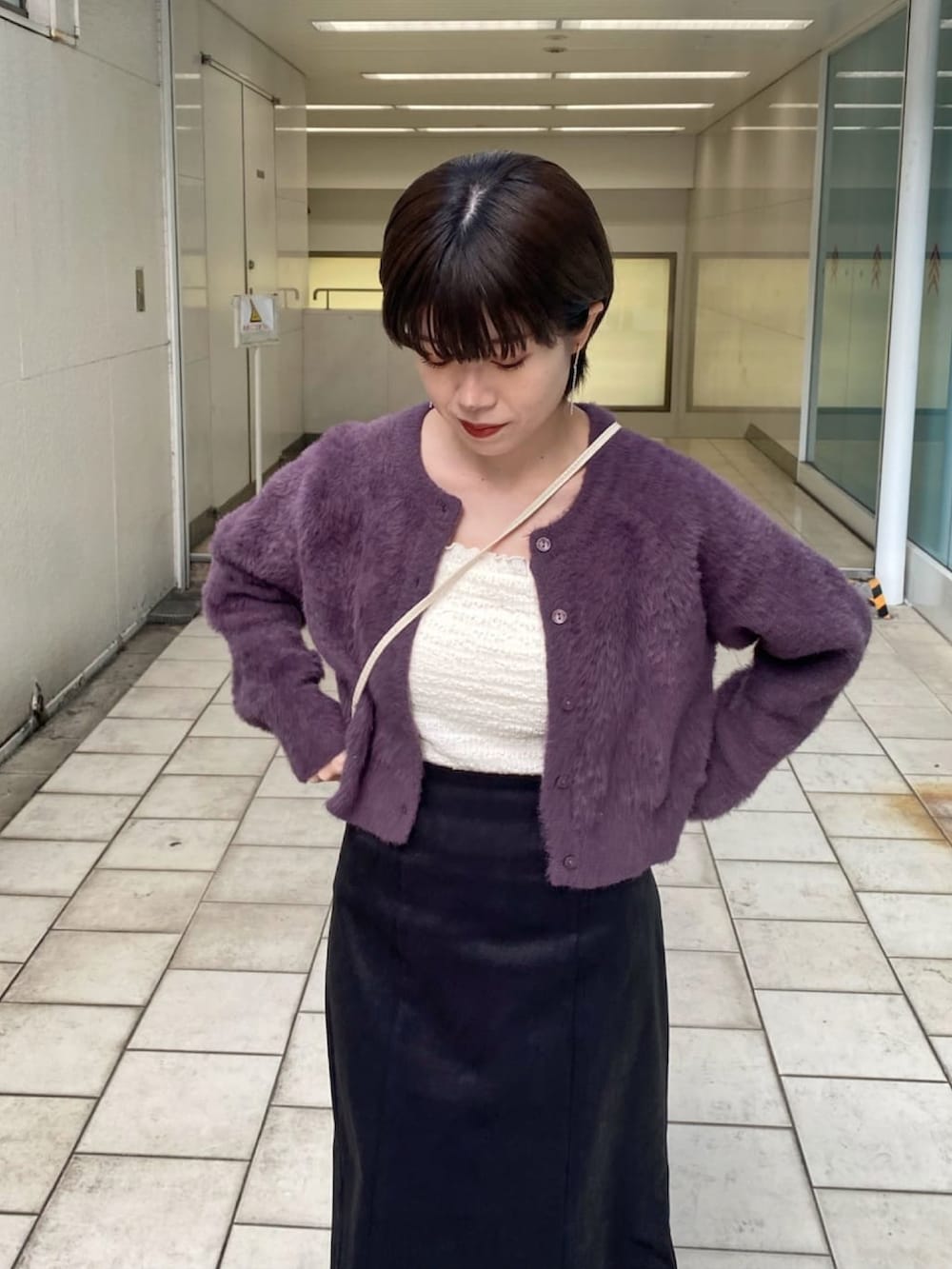 ホワイト系のキャミソール、パープル系のニット/セーター、ブラック系のスカートを着用したレディースの冬コーディネートの4枚目の写真