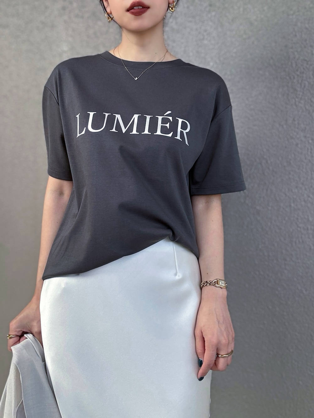 ブラック系のTシャツ/カットソー、ホワイト系のテーラードジャケット、ホワイト系のスカートを着用したレディースの夏コーディネートの3枚目の写真