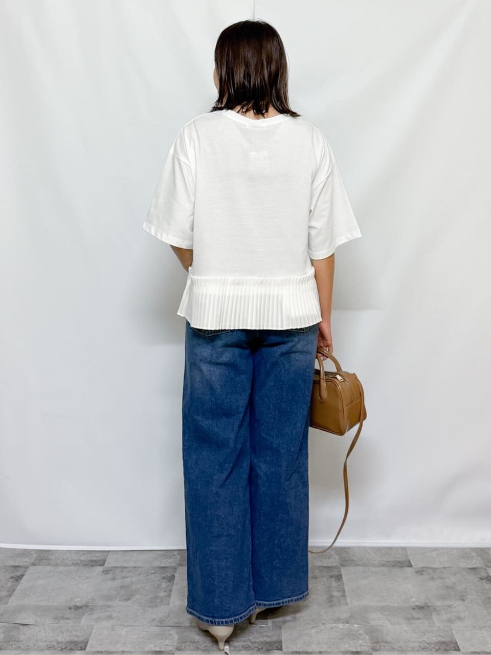 ホワイト系のTシャツ/カットソー、ブルー系のデニムパンツ、ベージュ系のショルダーバッグを着用したレディースの夏コーディネートの9枚目の写真