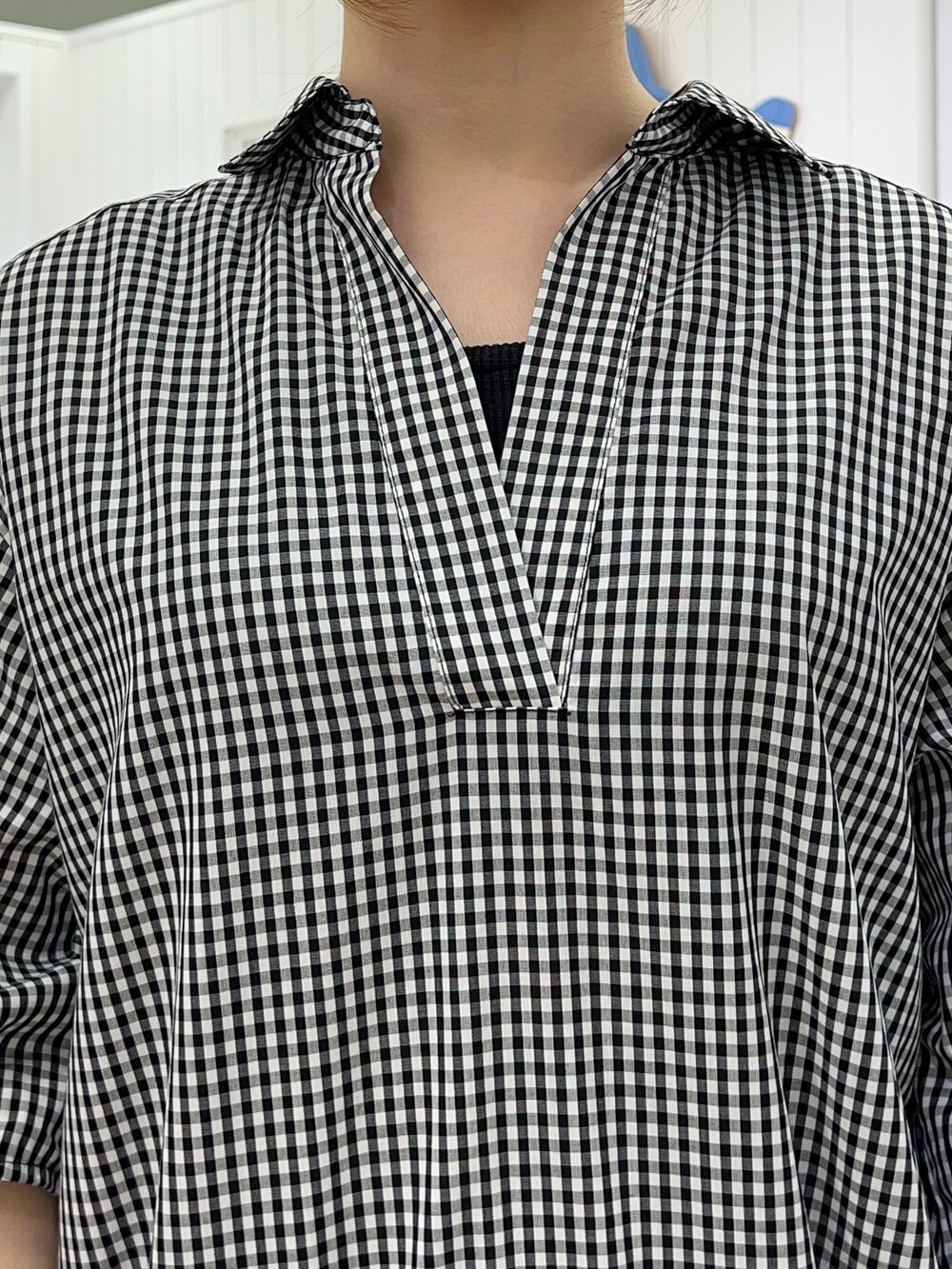 ブラック系のシャツ/ブラウス、ブルー系のスカート、グレー系のトートバッグを着用したレディースの春コーディネートの4枚目の写真