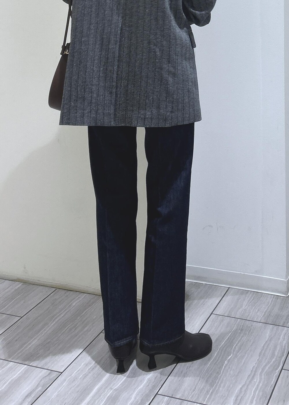 ブラック系のキャミソール、グレー系のテーラードジャケット、ブラウン系のブーツを着用したレディースの秋コーディネートの5枚目の写真