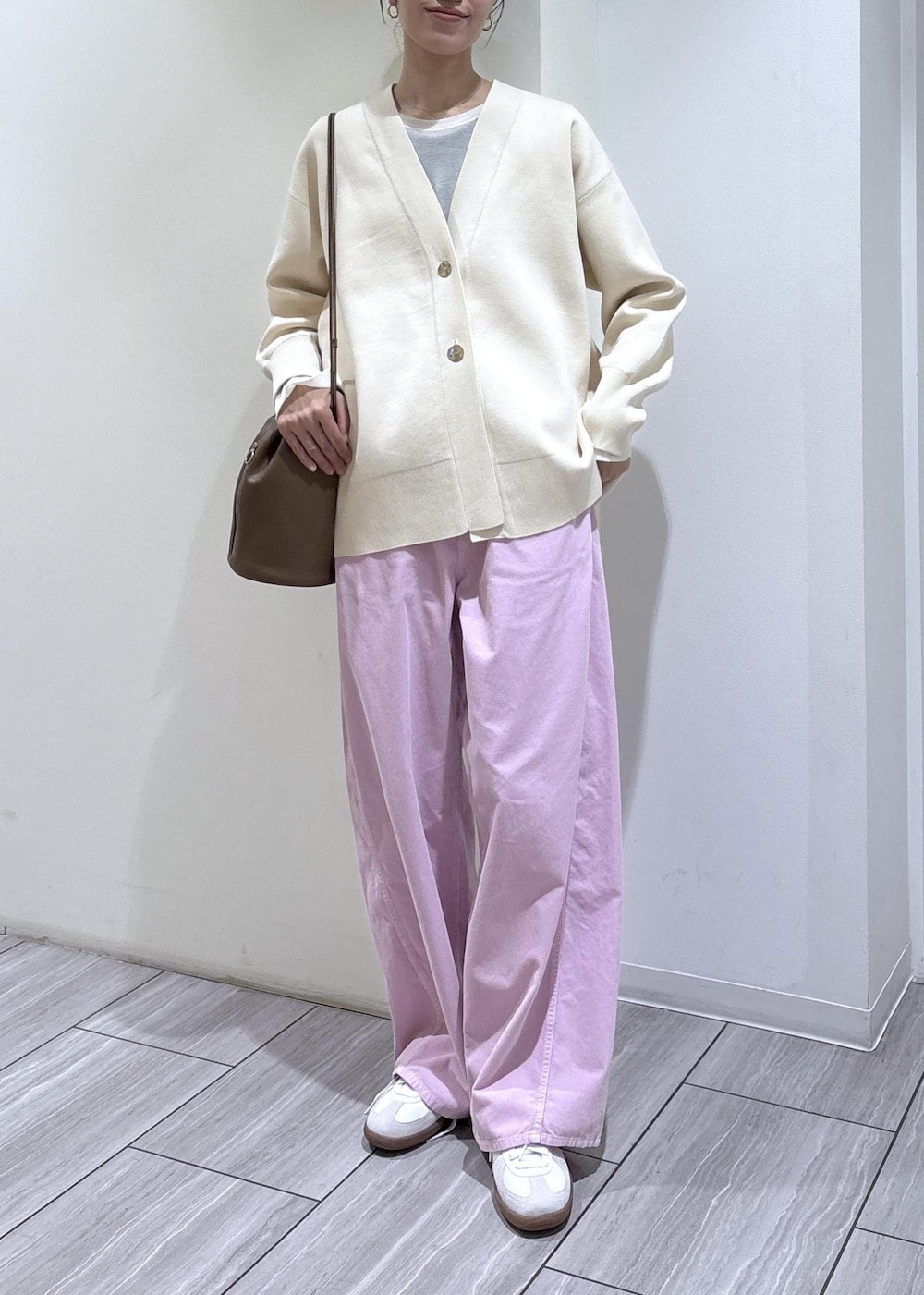 ホワイト系のスニーカー、ホワイト系のカーディガン/ボレロ、ブラウン系のショルダーバッグを着用したレディースの冬コーディネートの5枚目の写真