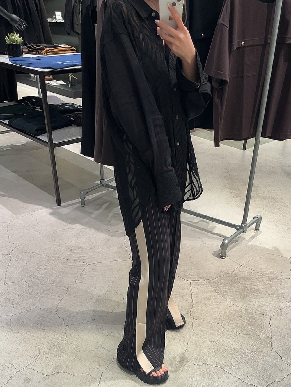 ブラック系のシャツ/ブラウス、ブラック系のスラックスを着用したレディースの夏コーディネートの2枚目の写真