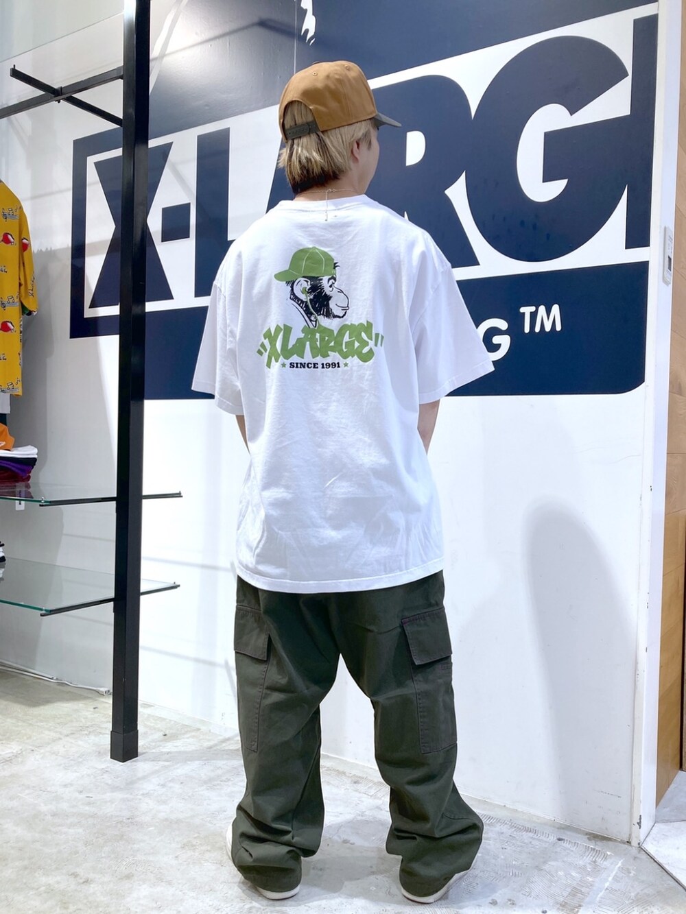 グリーン系のカーゴパンツ、ホワイト系のTシャツ/カットソー、ベージュ系のキャップを着用したメンズの夏コーディネートの4枚目の写真