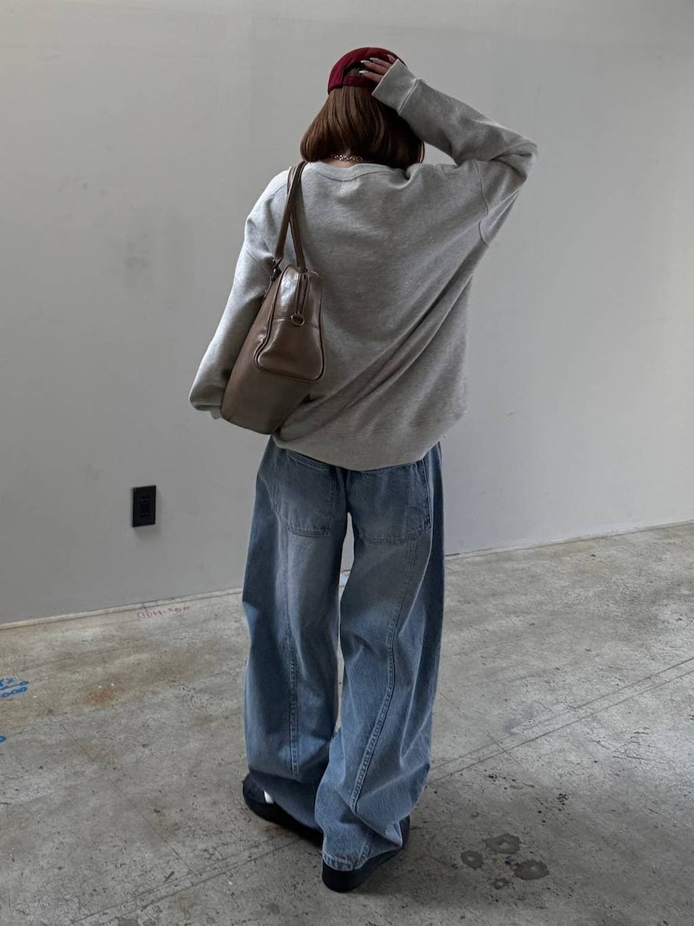 ブラウン系のボストンバッグ、グレー系のスウェットを着用したレディースの冬コーディネートの4枚目の写真