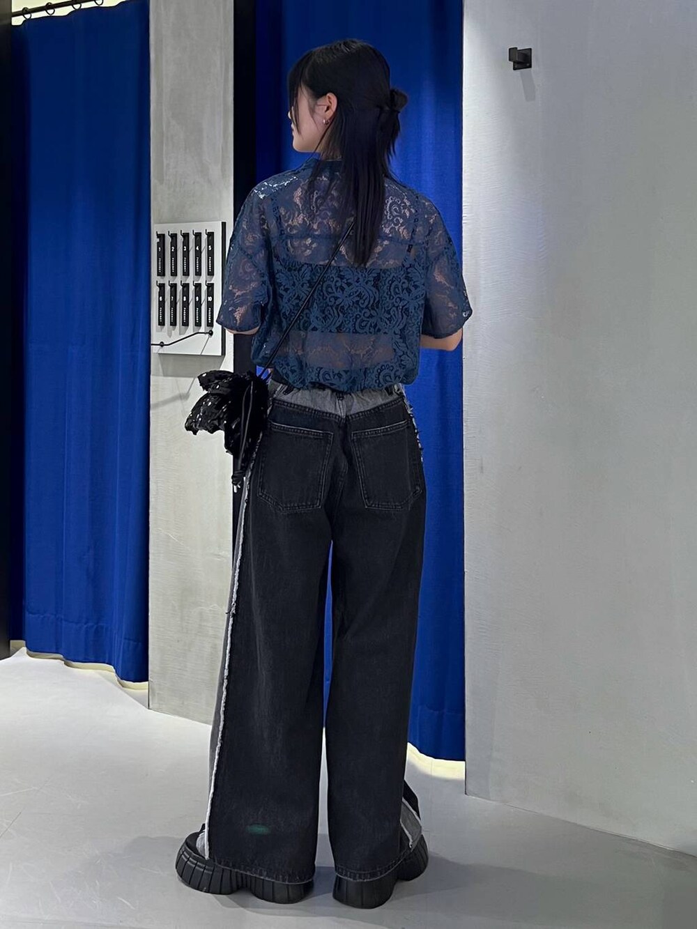 ブラック系のスニーカー、ブルー系のシャツ/ブラウス、ブラック系のキャミソールを着用したレディースの春コーディネートの4枚目の写真