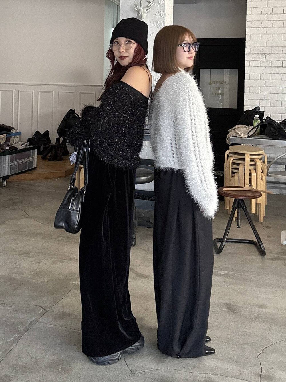 ブラック系のスニーカー、ブラック系のボストンバッグ、ブラック系のパンプスを着用したレディースの秋コーディネートの2枚目の写真