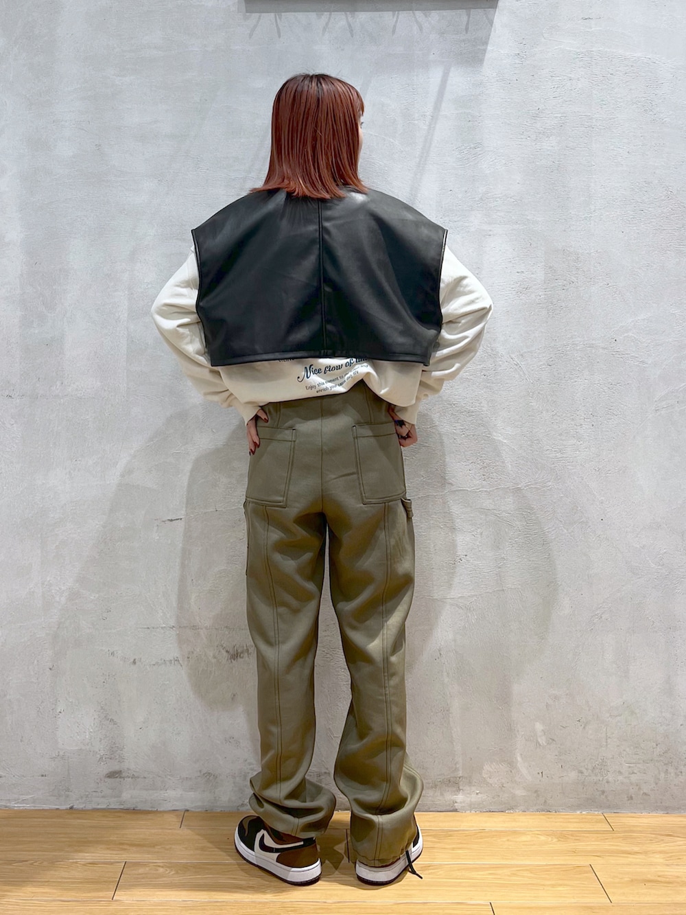 ブラウン系のその他パンツ、ホワイト系のスウェット、グリーン系のモッズコートを着用したレディースの冬コーディネートの2枚目の写真