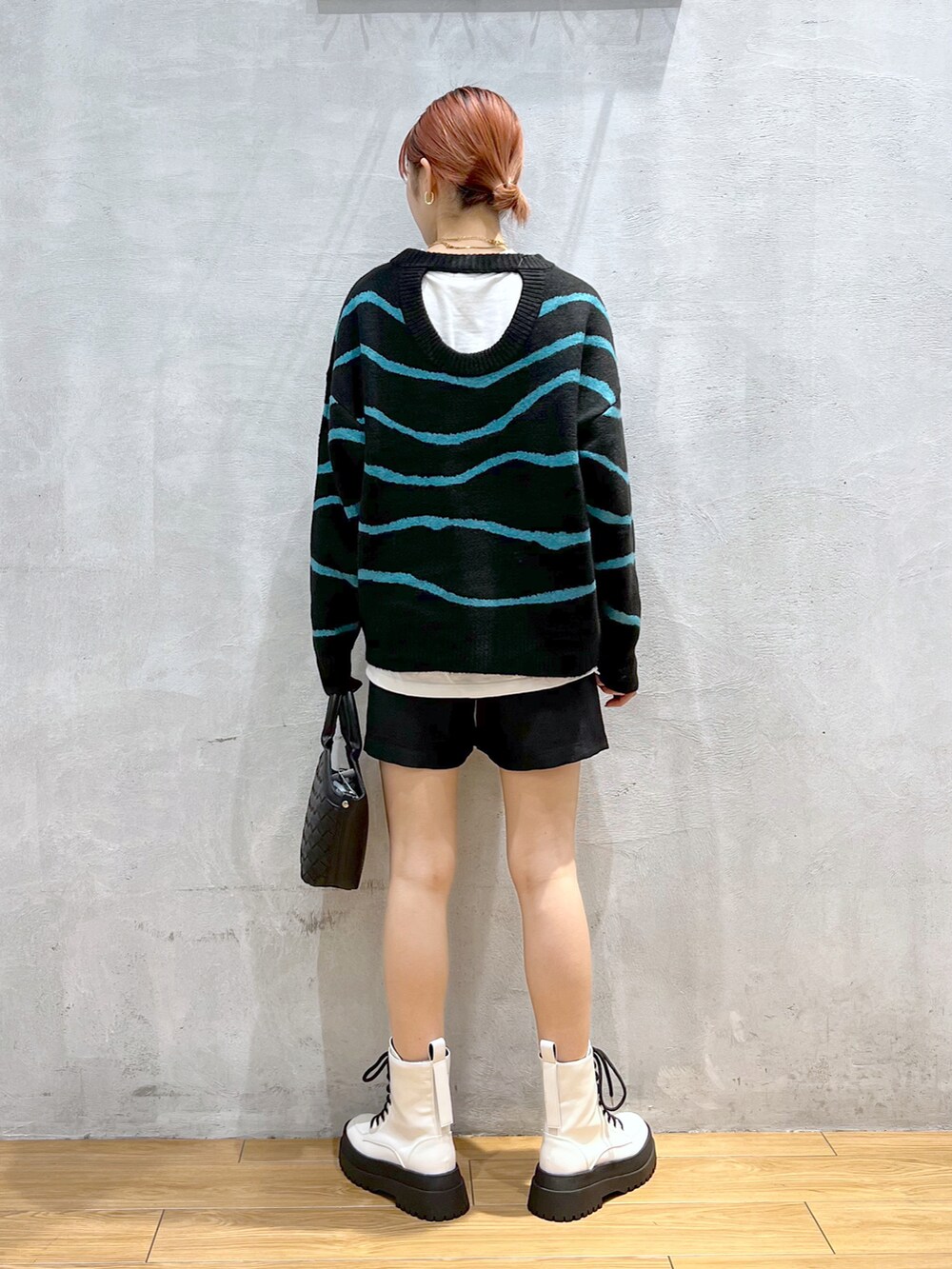 ブラック系のショルダーバッグ、ブラック系のニット/セーター、ブラック系のその他パンツを着用したレディースの冬コーディネートの2枚目の写真