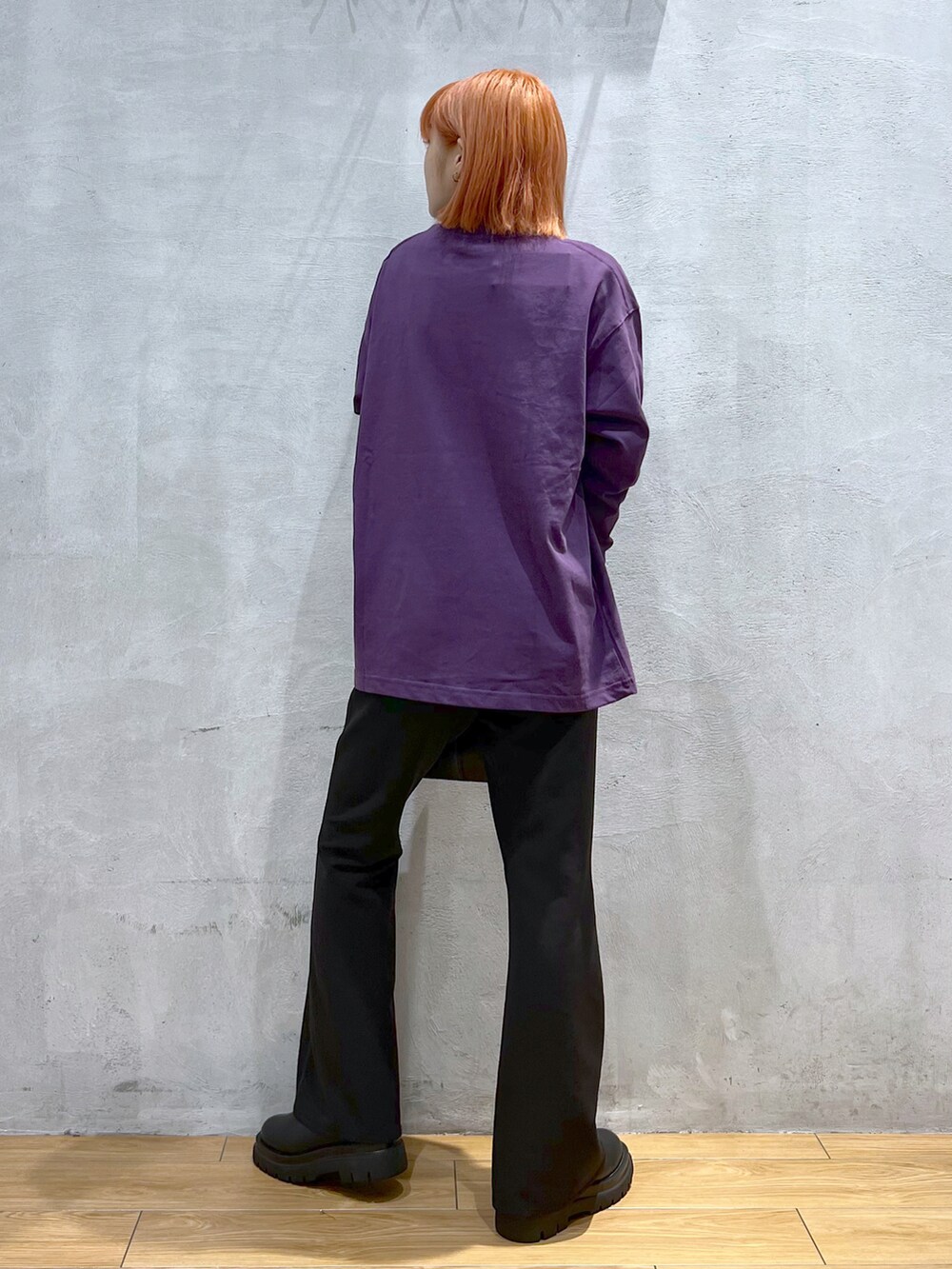 ブラック系のスラックス、ブラック系のショルダーバッグ、パープル系のTシャツ/カットソーを着用したレディースの秋コーディネートの4枚目の写真