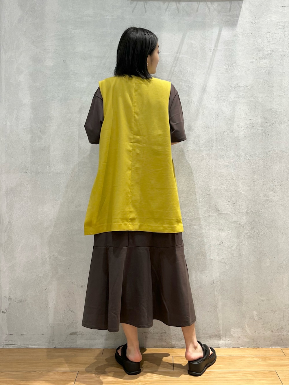 ブラック系のサンダル、ブラウン系のワンピース、イエロー系のその他アウターを着用したレディースの夏コーディネートの3枚目の写真