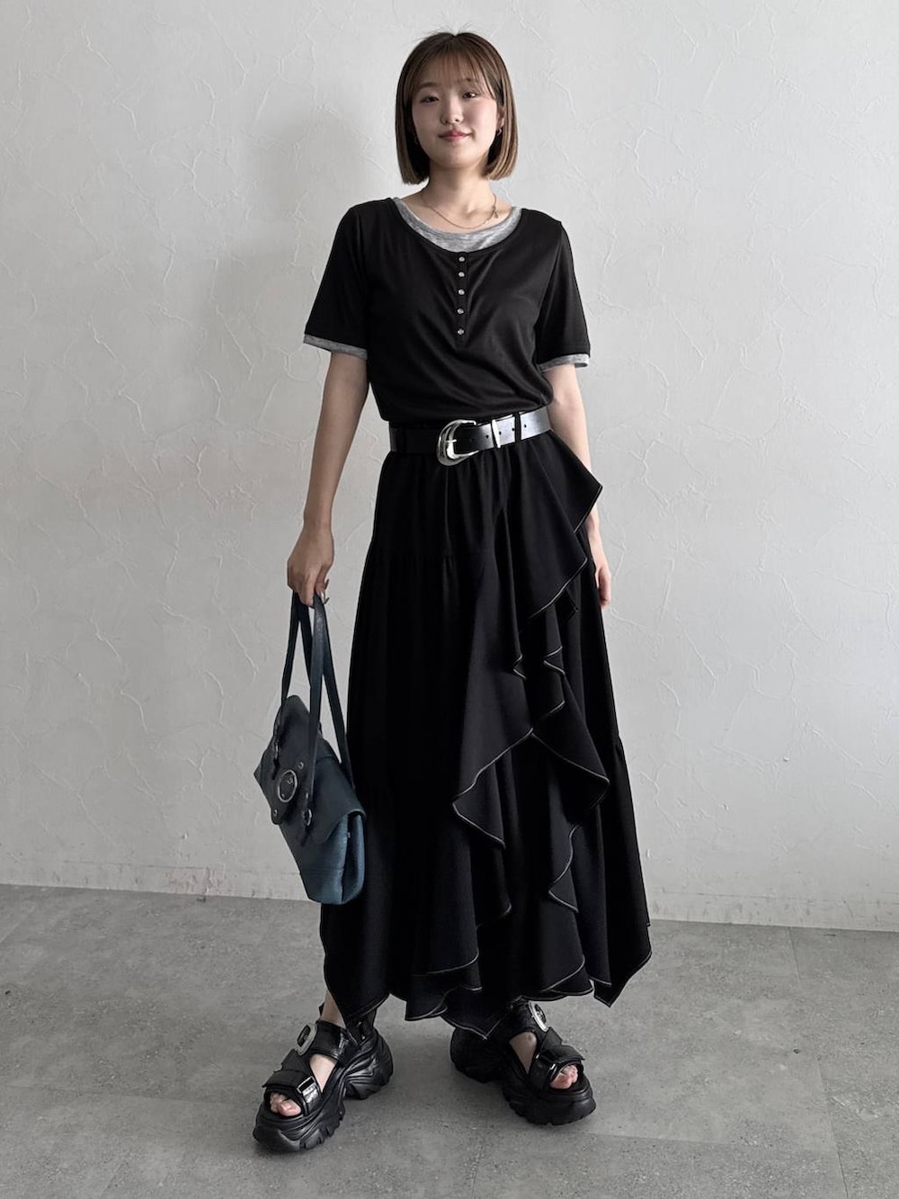 ブラック系のスカート、ブラック系のサンダル、ブラック系のTシャツ/カットソーを着用したレディースの夏コーディネートの7枚目の写真