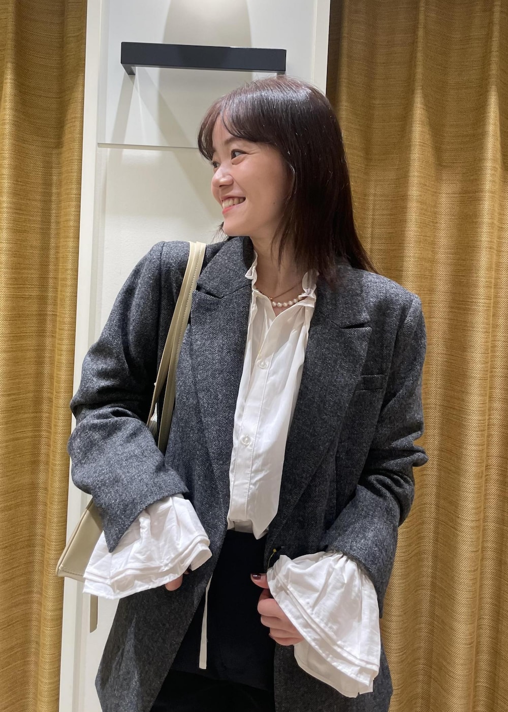 ブラック系のチノパンツ、ホワイト系のシャツ/ブラウス、ブラック系のテーラードジャケットを着用したレディースの秋コーディネートの5枚目の写真