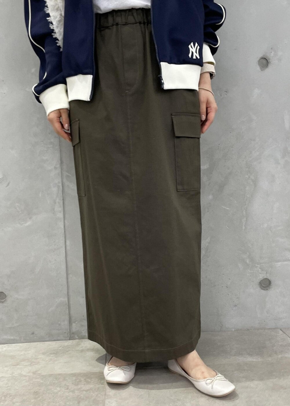 ホワイト系のショルダーバッグ、グリーン系のスカート、ホワイト系のバレエシューズを着用したレディースの秋コーディネートの6枚目の写真