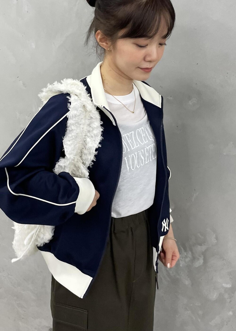 ホワイト系のショルダーバッグ、グリーン系のスカート、ホワイト系のバレエシューズを着用したレディースの秋コーディネートの10枚目の写真