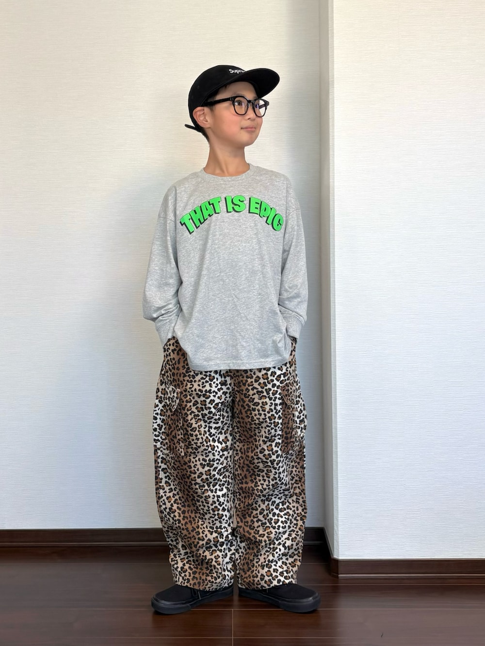 ブラック系のスニーカー、グレー系のTシャツ/カットソー、ブラウン系のカーゴパンツを着用したキッズの秋コーディネートの2枚目の写真