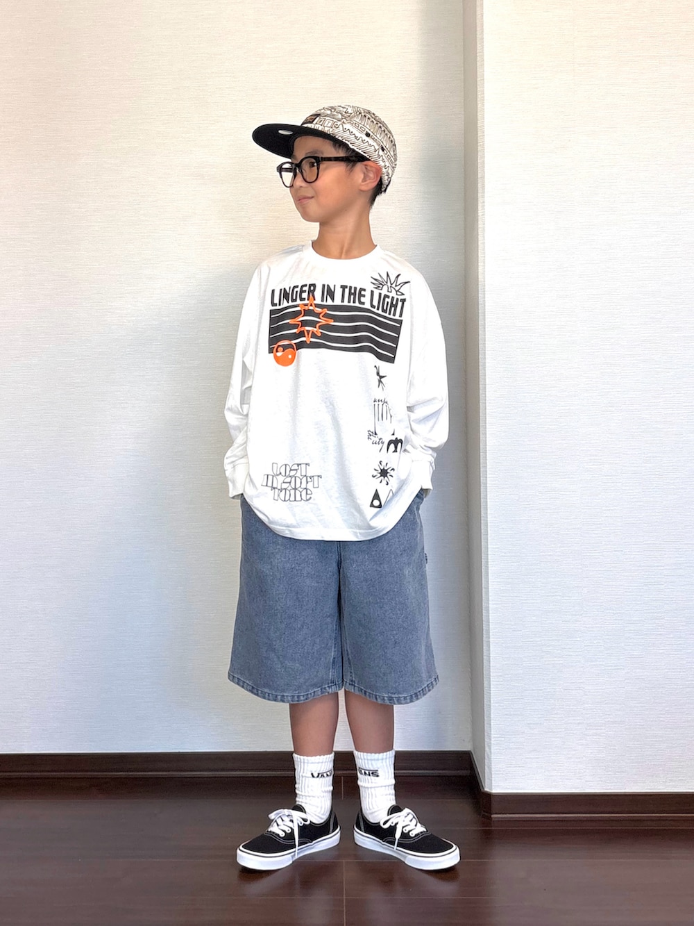 ホワイト系のTシャツ/カットソー、ブルー系のその他パンツ、ブラック系のスニーカーを着用したキッズの秋コーディネートの2枚目の写真