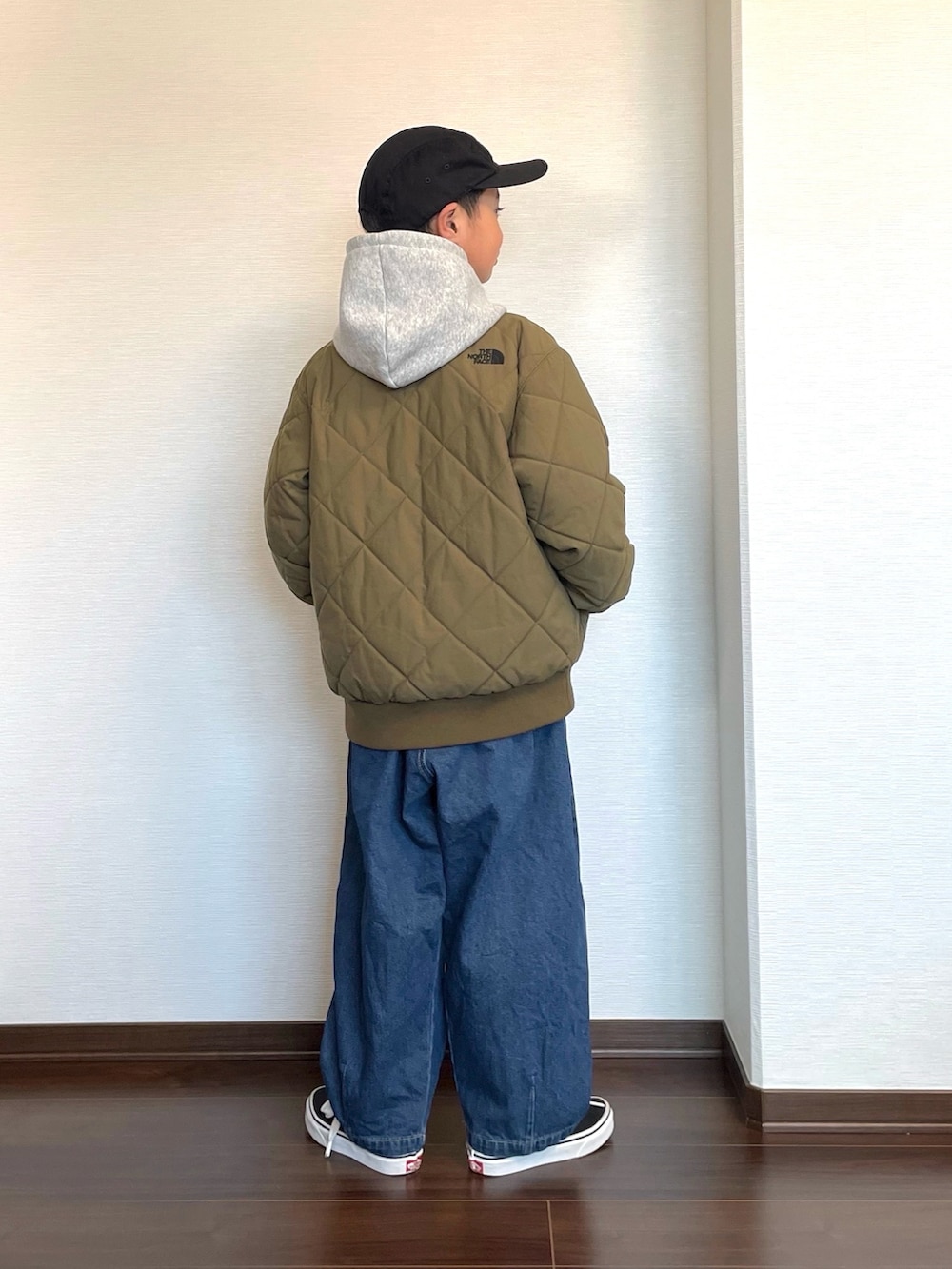 グレー系のパーカー、ブルー系のその他パンツ、グリーン系のダウンジャケット/コートを着用したキッズの冬コーディネートの2枚目の写真