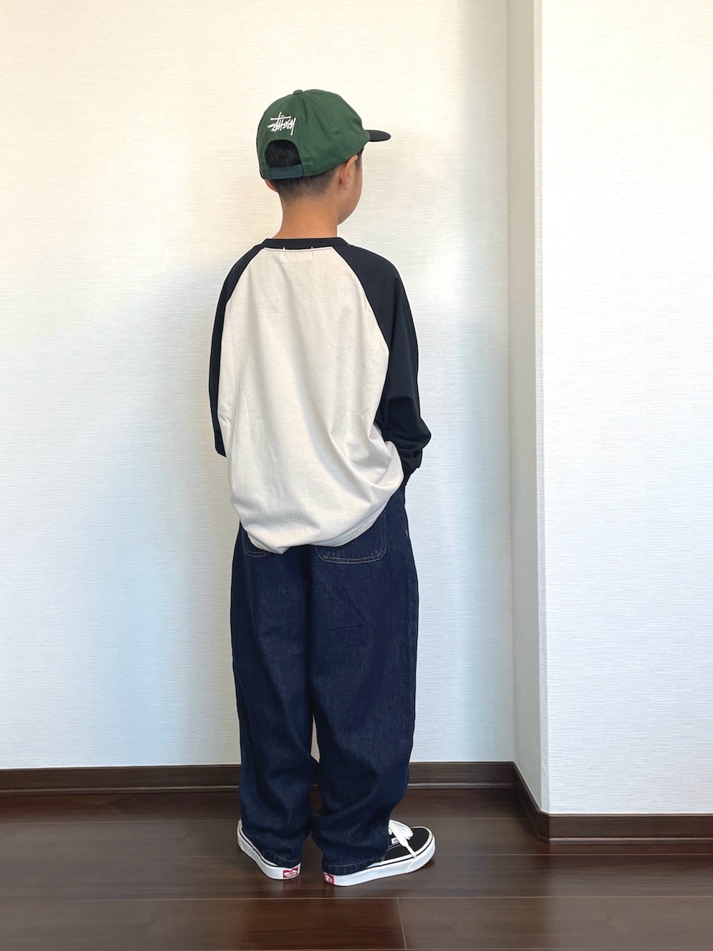 ブラック系のTシャツ/カットソー、ブラック系のスニーカー、その他のデニムパンツを着用したキッズの秋コーディネートの2枚目の写真