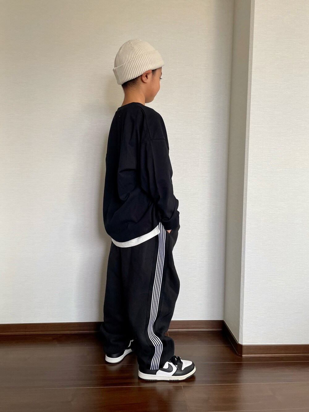 ブラック系のTシャツ/カットソー、ホワイト系のタンクトップ、ブラック系のセットアップを着用したキッズの秋コーディネートの2枚目の写真