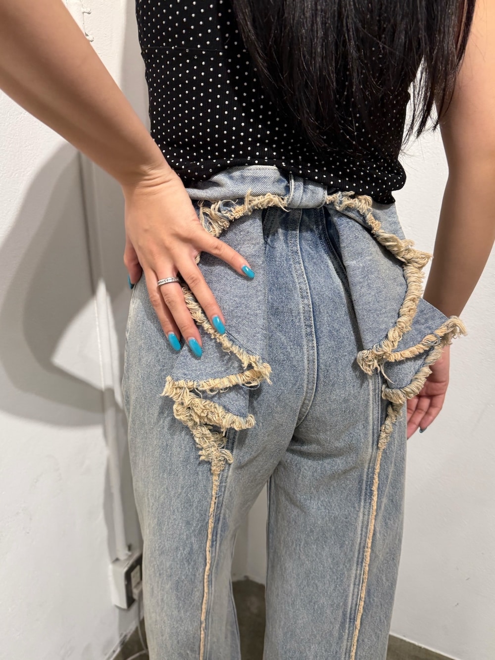 ブルー系のデニムパンツを着用したレディースの春コーディネートの2枚目の写真