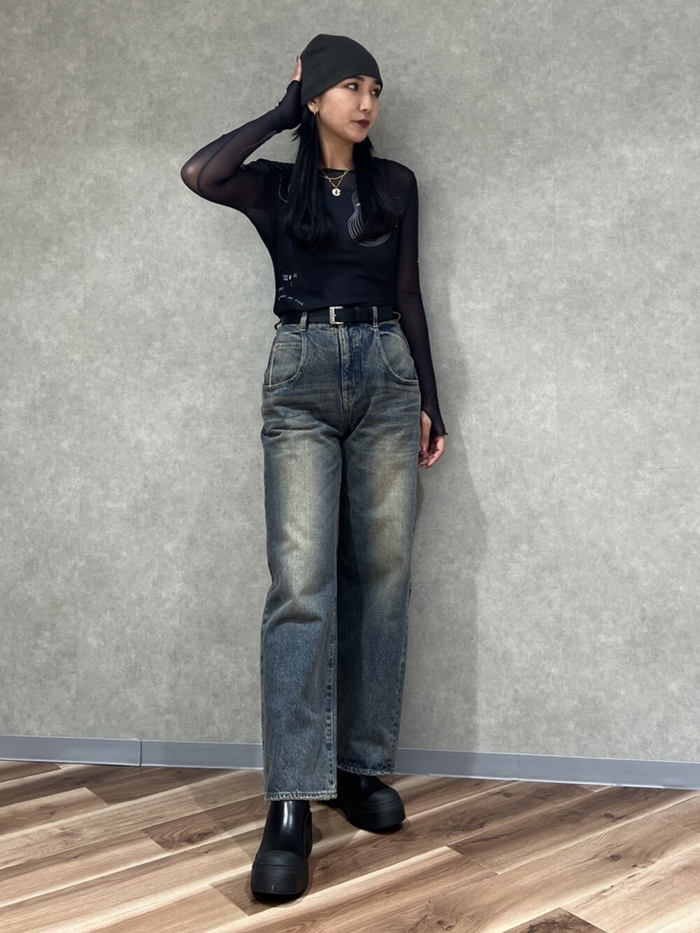 ブラック系のTシャツ/カットソー、ブルー系のデニムパンツ、ブラック系のブーツを着用したレディースの秋コーディネートの3枚目の写真